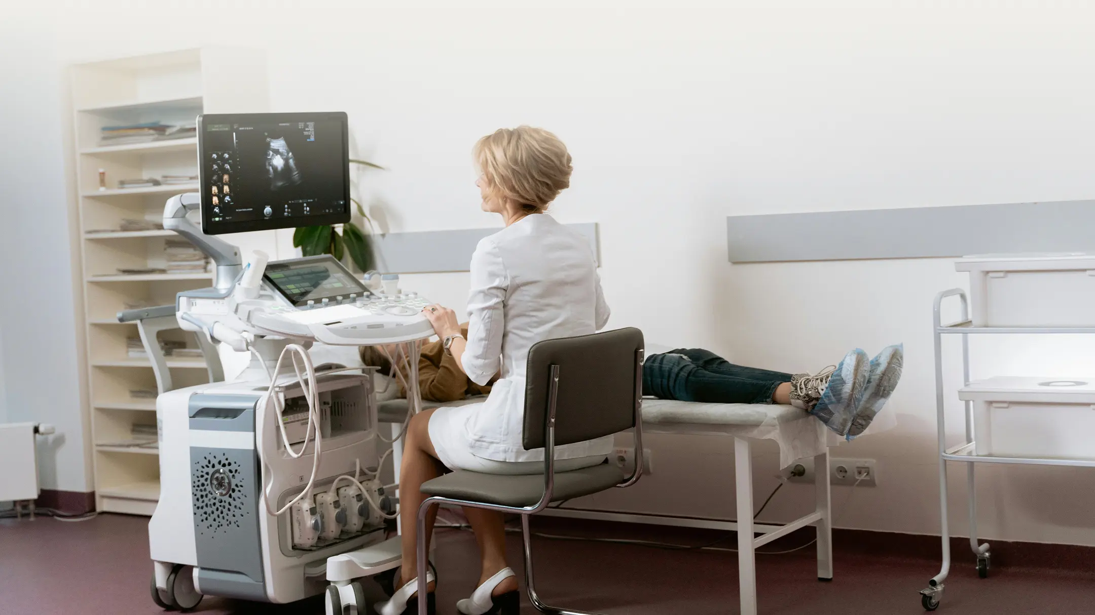 A woman sitting in a chair in front of a computer.