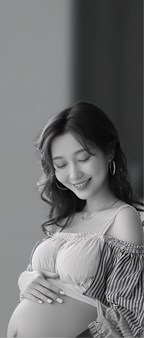 A pregnant woman smiles while holding a book.