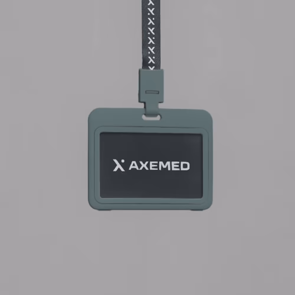 Gray badge holder with a black card displaying the AXEMED logo, hanging from a lanyard with a repeating AXEMED pattern.