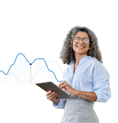 Analyst using a tablet in front of a data chart