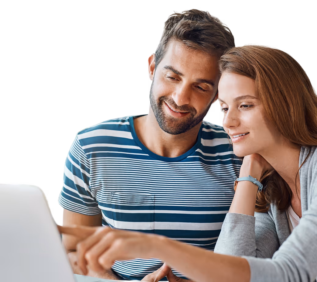 Man and woman looking at a laptop screen, with the man pointing at it and both smiling.