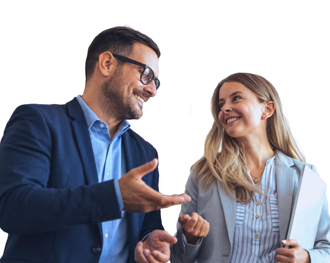 Man in glasses and suit jacket talking and smiling with woman holding documents.