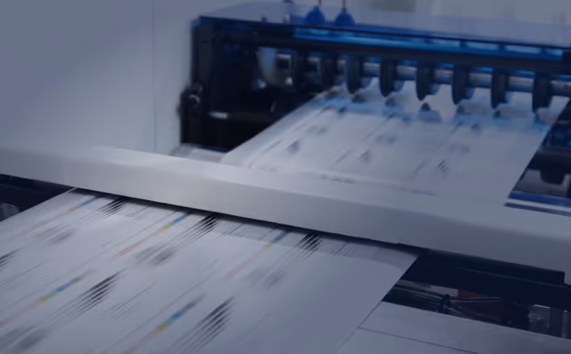 Close-up of a printer producing color-printed documents rapidly.