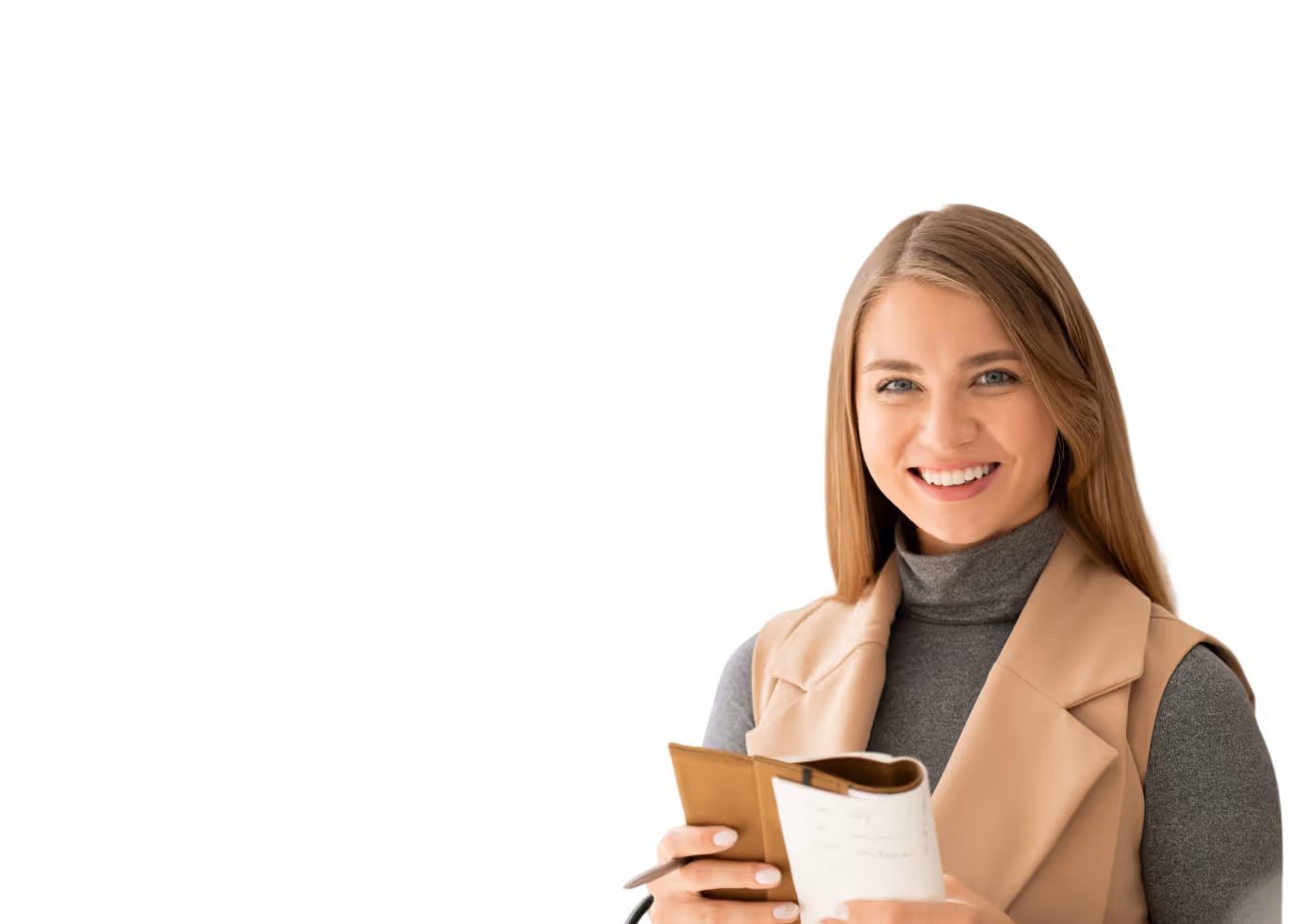 Smiling woman wearing a gray turtleneck and tan vest holding a notebook and pen.