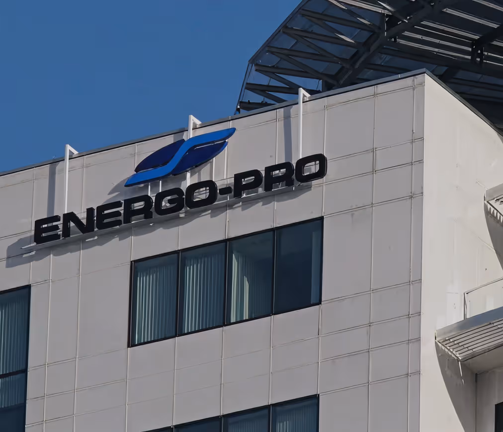 White office building facade with large black text 'ENERGO-PRO' and a blue company logo above windows.