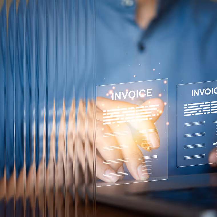 Person interacting with a digital touchscreen displaying glowing virtual invoice documents.