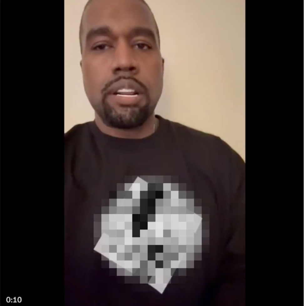Kanye West wearing shirt with swastika