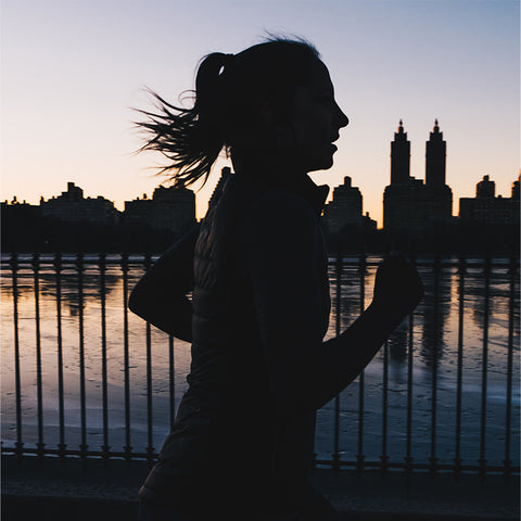Silhouette of woman running early in the morning