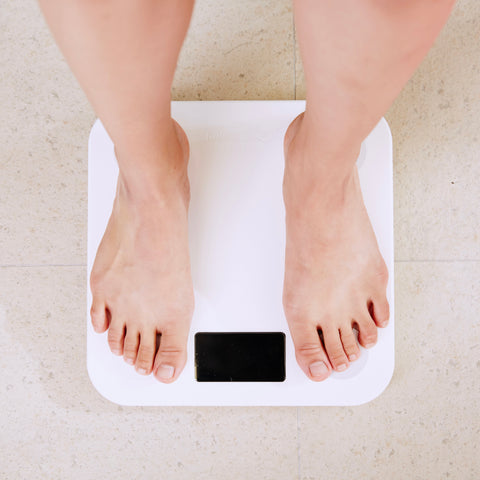 Woman standing on white digital scale