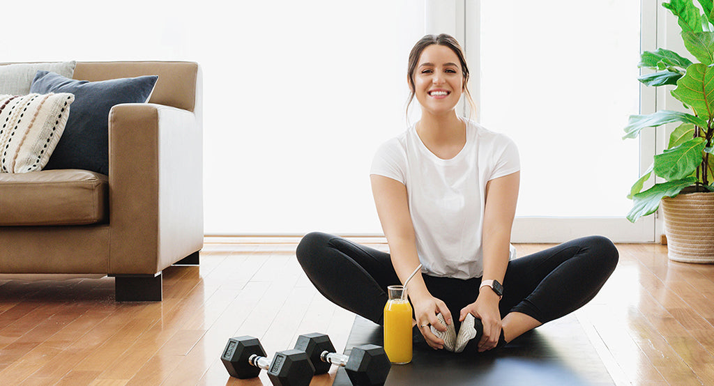 Leah Itsines in stylish living room for a home BARE Lean workout