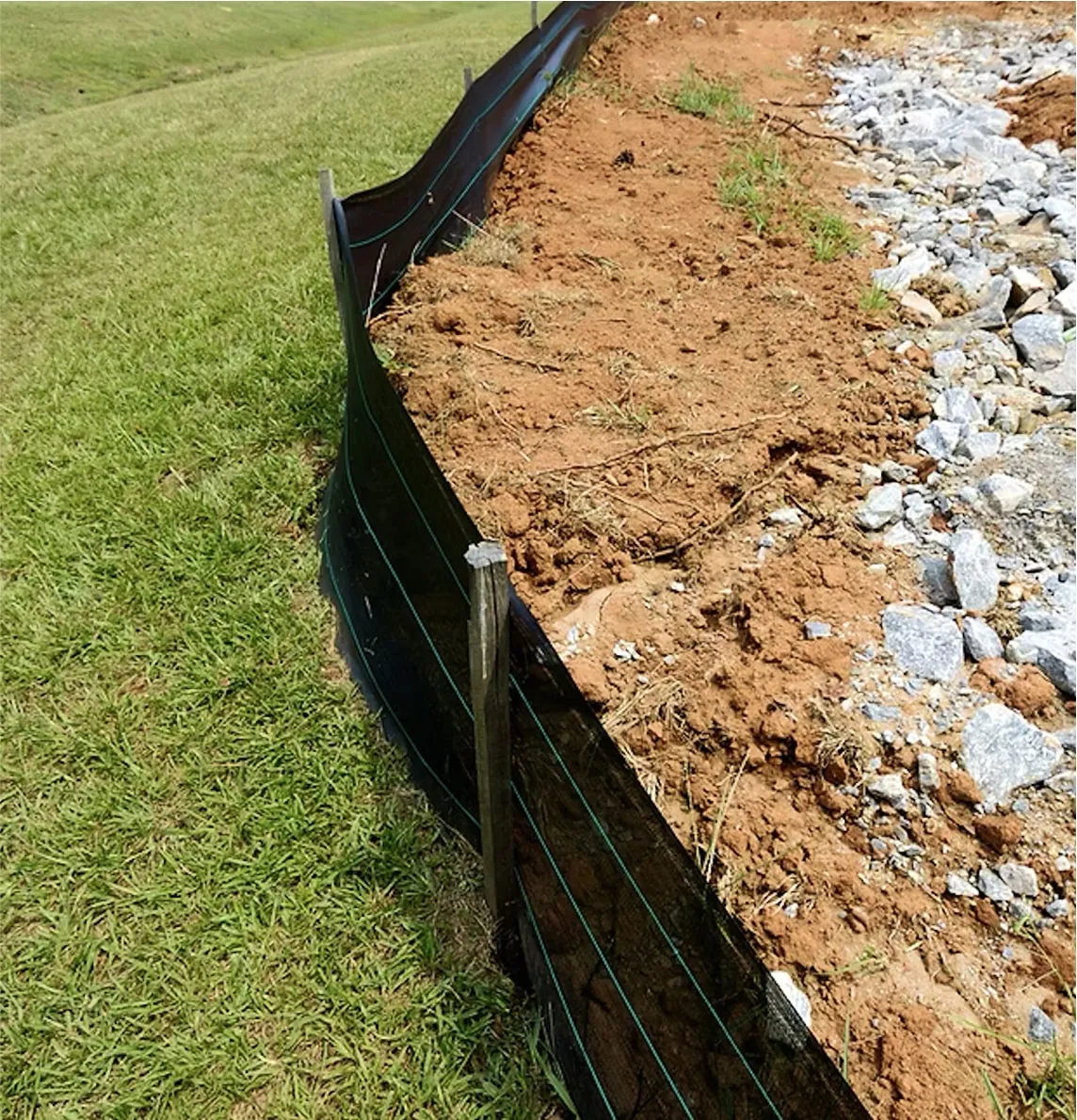 Slope with erosion-control fencing and soil stabilization
