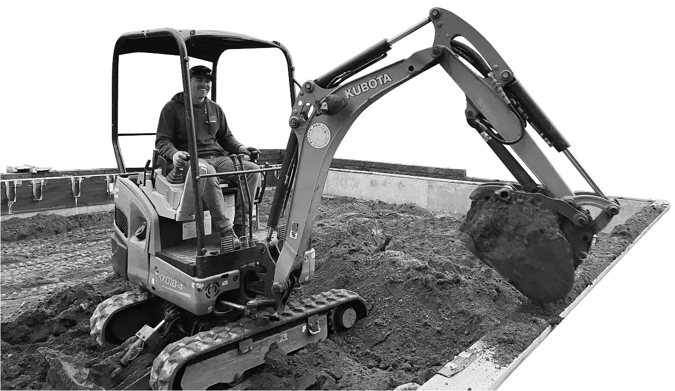 Excavator loading soil on construction site for drainage installation