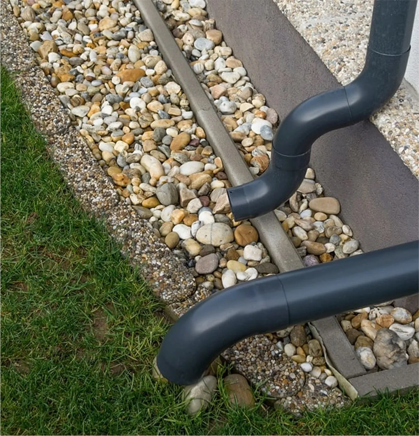 Residential downspout extension directing water away from foundation