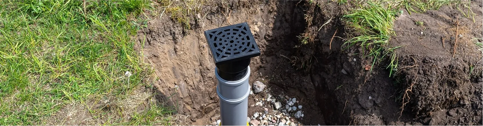 Drywell pit with PVC inflow pipe for subsurface water absorption