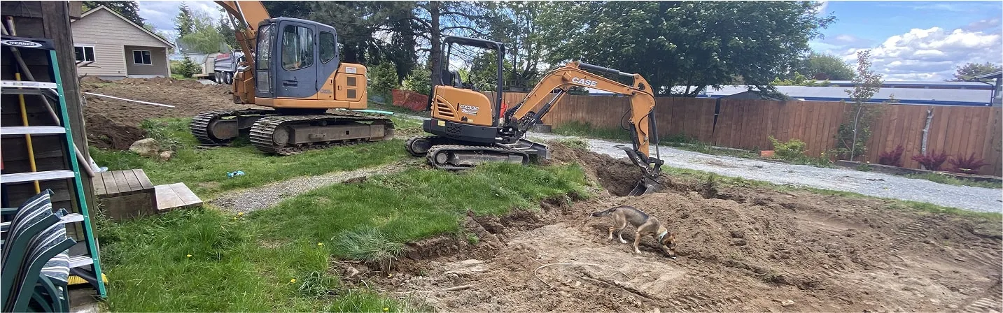 Workers leveling and grading residential yard for proper drainage