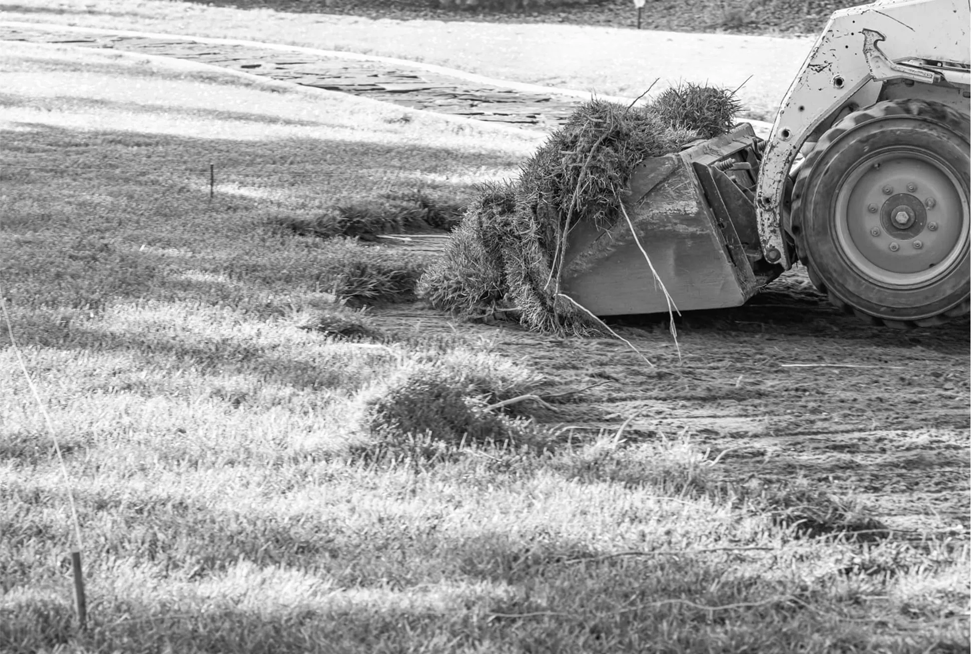 Residential backyard drainage excavation with construction machinery