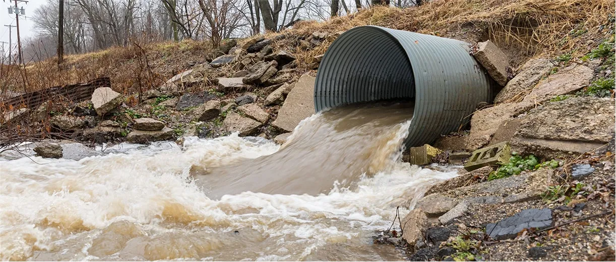 Culvert pipe releasing water into natural stream channel