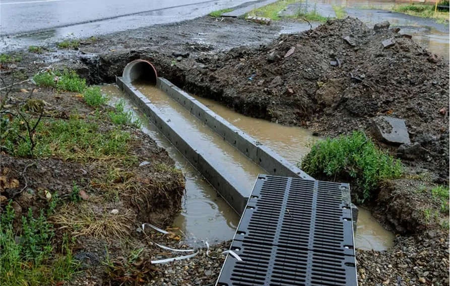 Retention pond for stormwater runoff surrounded by green landscape