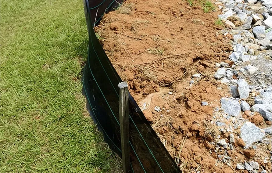 Soil erosion-control fencing beside construction drainage trench