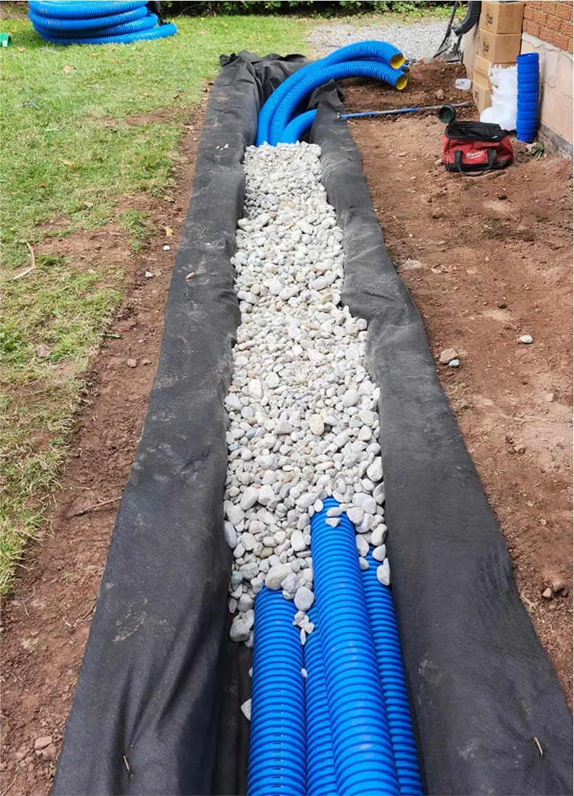 Blue corrugated pipes installed for residential yard drainage system