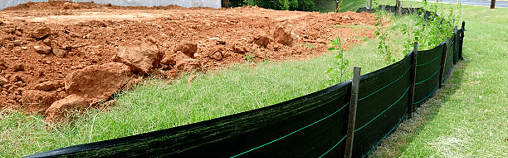 Erosion-control fencing installed on newly graded slope