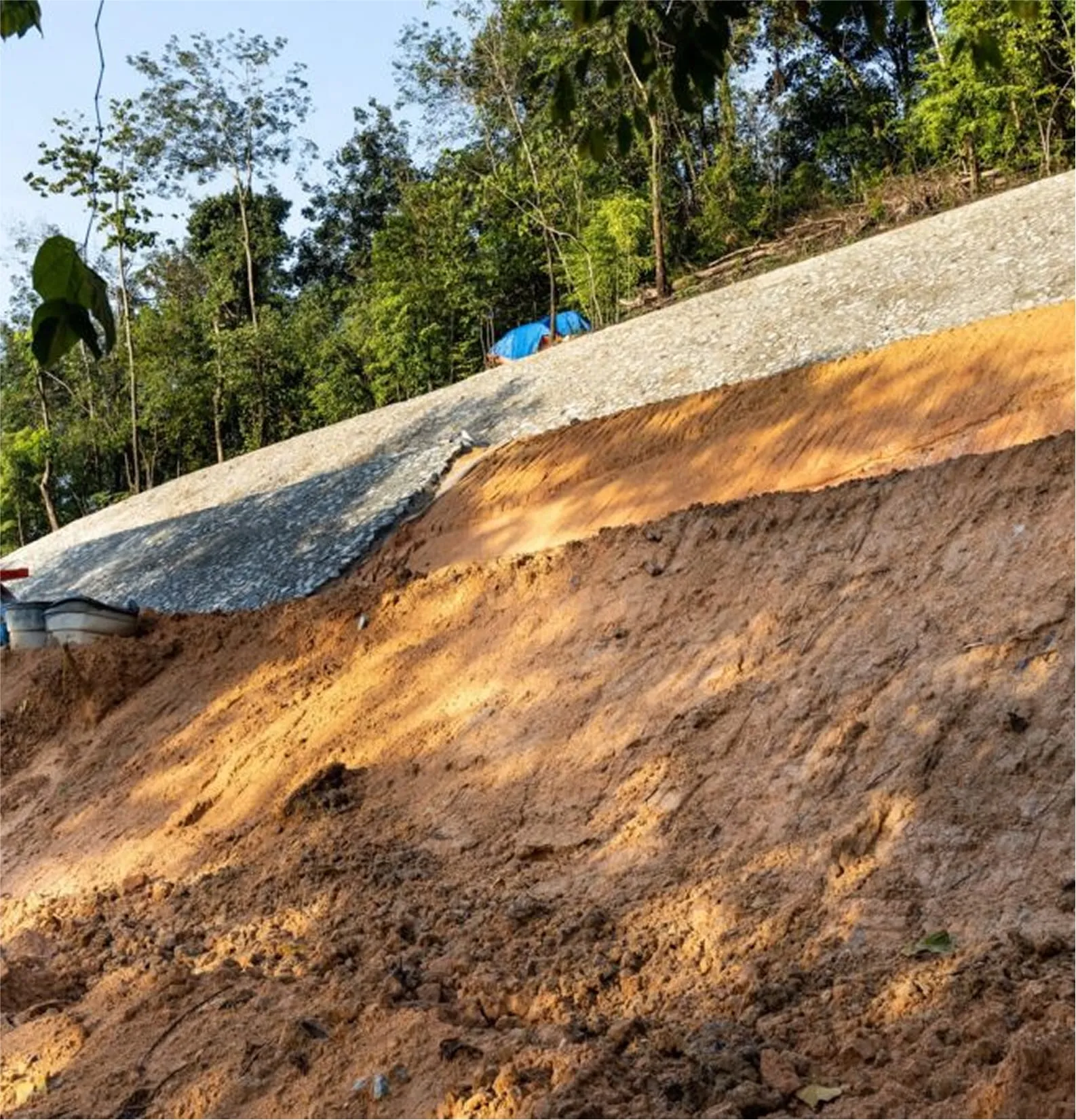 Slope stabilization project using matting and drainage channel protection