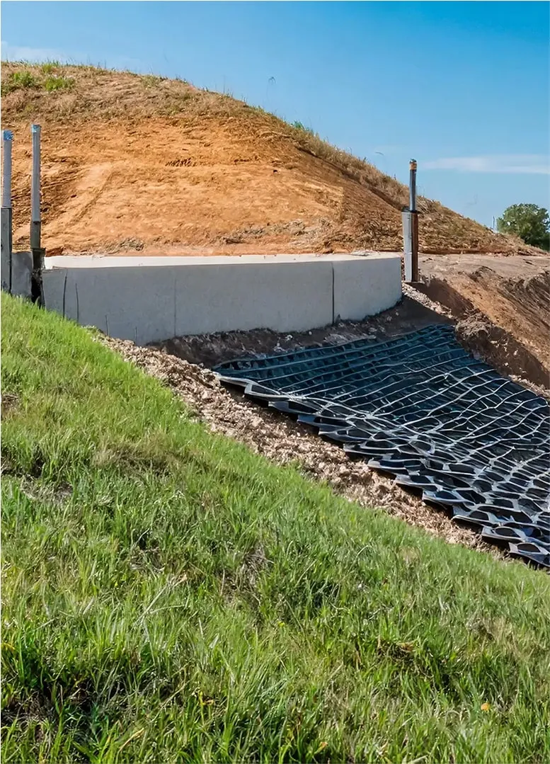 Retaining wall and drainage structure built on compacted soil slope