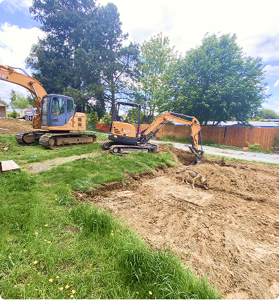 Excavators grading landscape for drainage system preparation