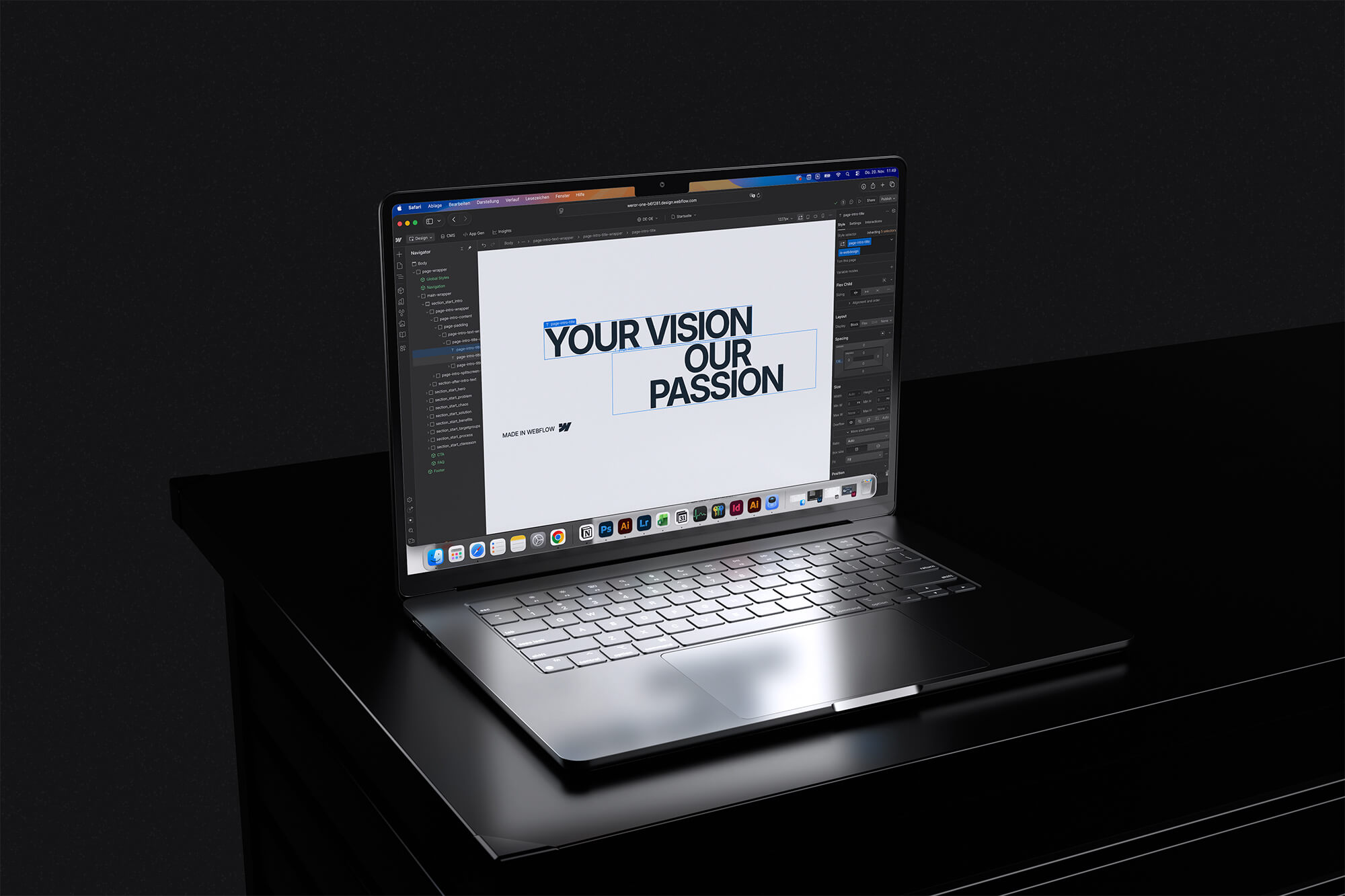 Offener Laptop auf schwarzem Tisch zeigt Webdesign-Software mit dem Text 'YOUR VISION OUR PASSION'.