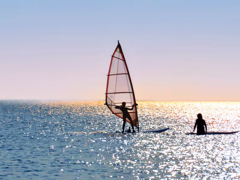 A person wind-surfing on open water