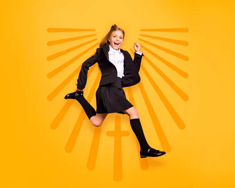 Smiling schoolgirl in uniform jumping with joy against a yellow background featuring a cross and radiating lines.