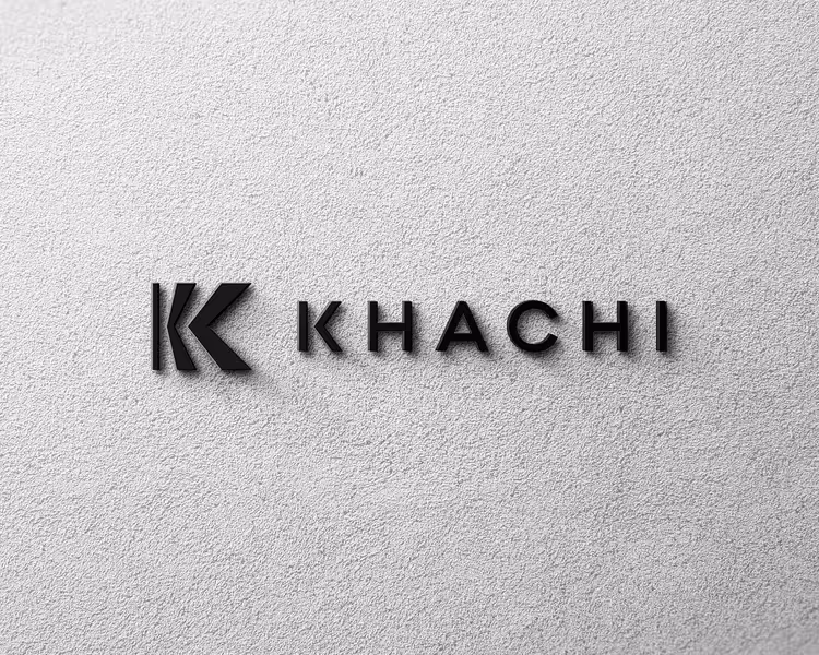 Black 3D letters spelling KHACHI with a stylized K logo on a textured white wall.