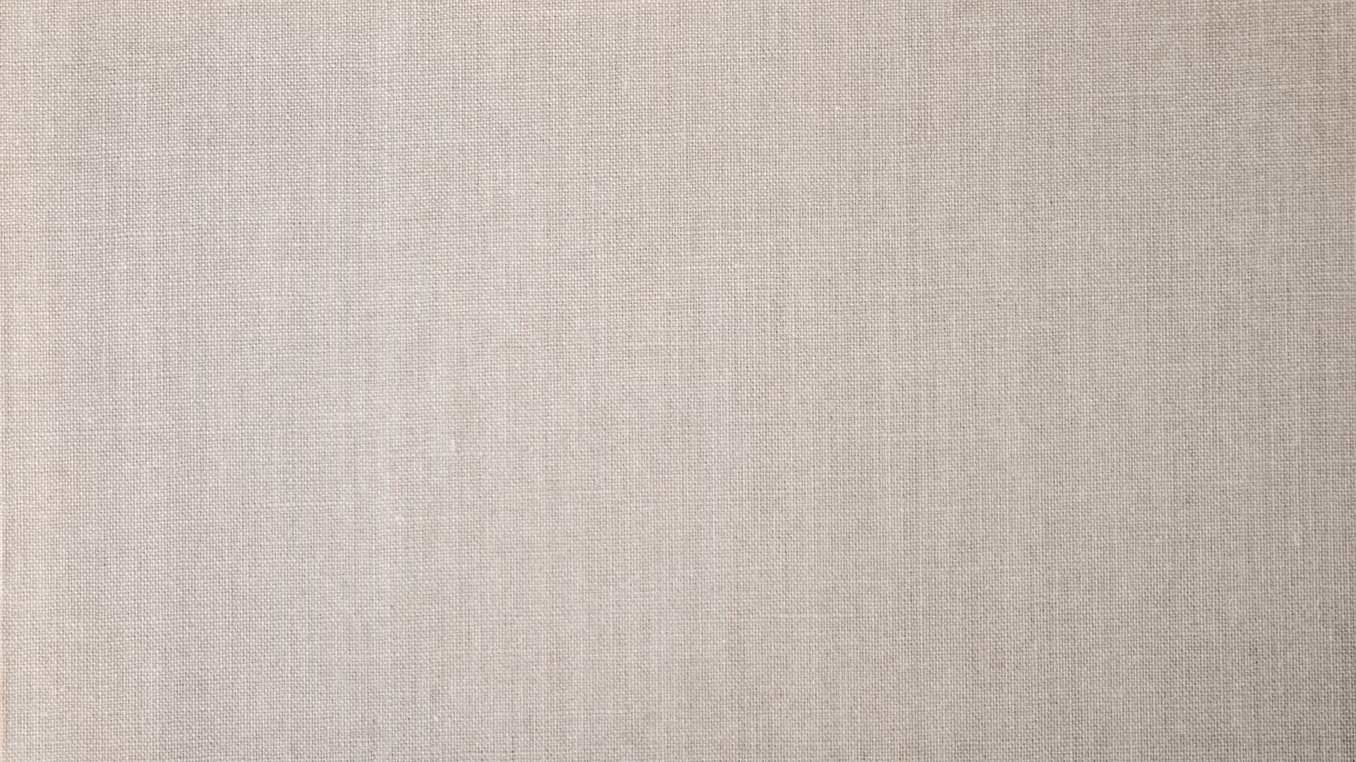 Close-up of beige woven fabric texture with a grid-like pattern.