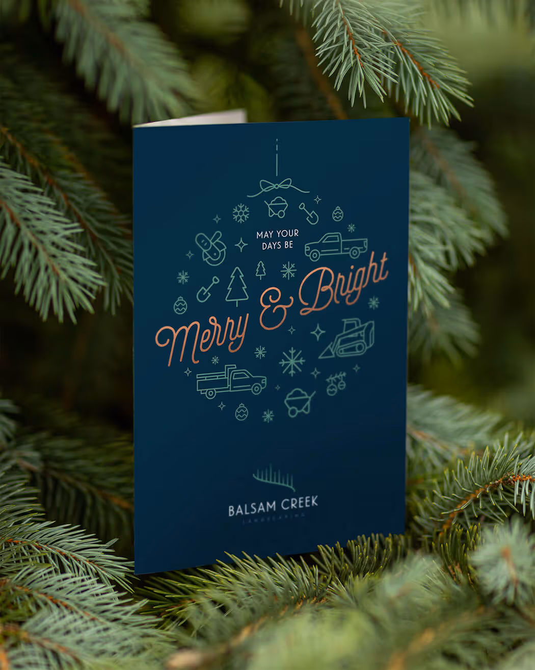 Holiday card with message 'May your days be Merry & Bright' surrounded by landscaping icons, set among green pine branches.