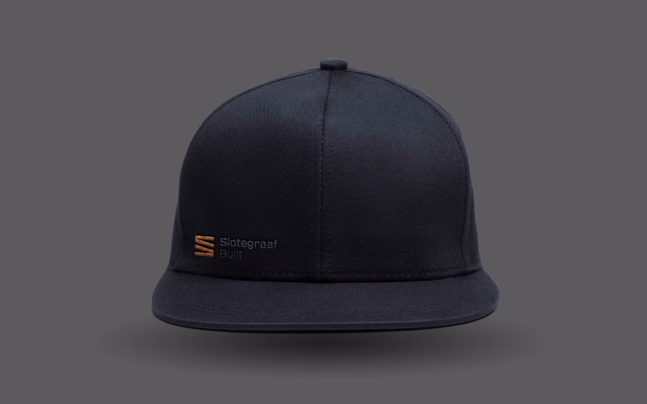 Black baseball cap with an orange and black Slotegraaf Built logo on front left panel.