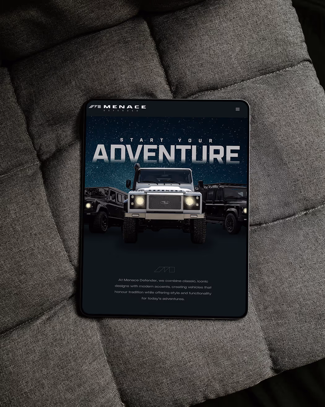 Tablet displaying Menace Defender website with three off-road vehicles under the text 'Start Your Adventure'.
