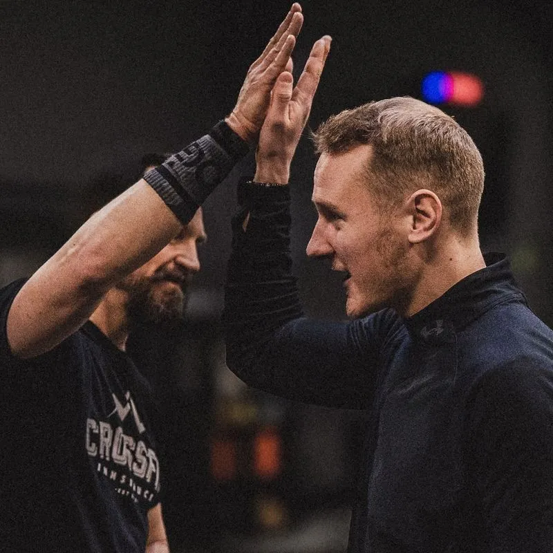 two people high five in gym