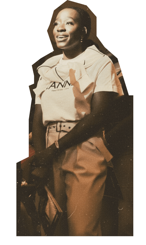 A woman stands smiling, wearing a white t-shirt, light high-waisted pants, and holding a bag. The image has a sepia tone and a cut-out effect.