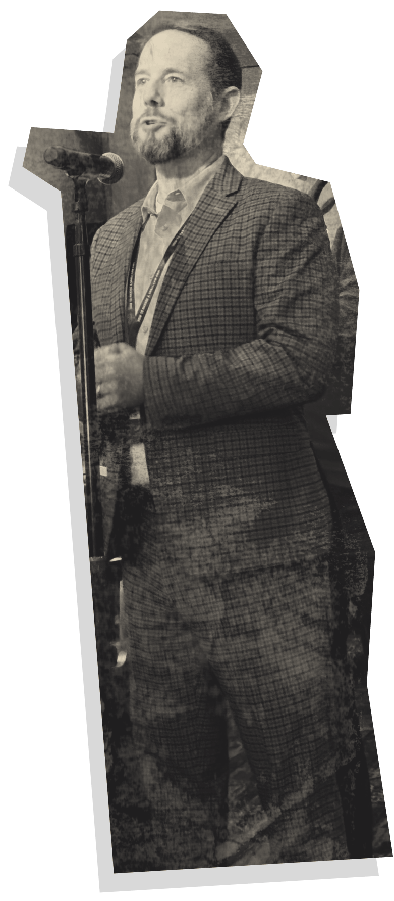 A participant asking a question during the How to Manage a Small Law Firm event, standing in the crowd with a microphone in hand. The individual is dressed in a plaid suit, engaging with the speaker on stage, highlighting the interactive nature of the event and the value of audience participation in law firm management coaching.