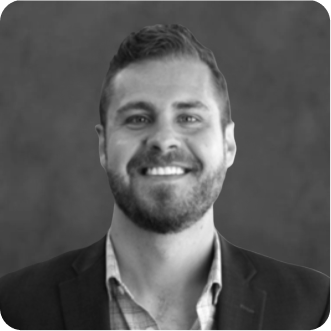 Headshot of William L. Host, Director of Acquisition PA at How to Manage a Small Law Firm, wearing a dark suit jacket and plaid button up smiling.