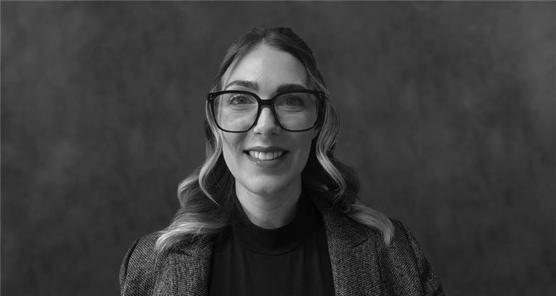 Headshot of Tracey A. Sherwood, Advisor - CEO at How to Manage a Small Law Firm, wearing a dark suit jacket and glasses smiling.