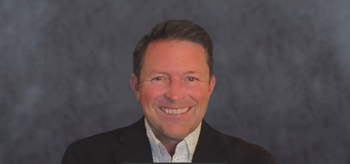 Headshot of Alexander Martinez, Sr. IT Managet at How to Manage a Small Law Firm, wearing a dark suit jacket and white button up and tie and smiling.