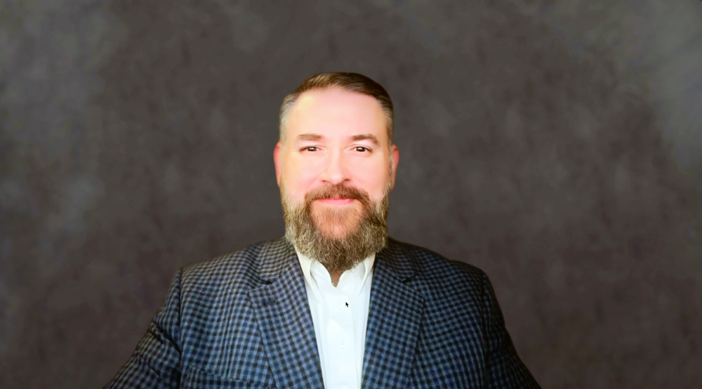 Headshot of Nicholas A. Correa, FP&A Accounting Specialist at How to Manage a Small Law Firm, wearing a dark suit jacket and white button up, smiling.