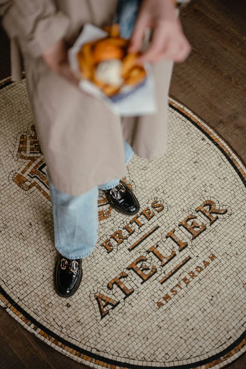 A photo of a Frites Atelier floor with their logo in it
