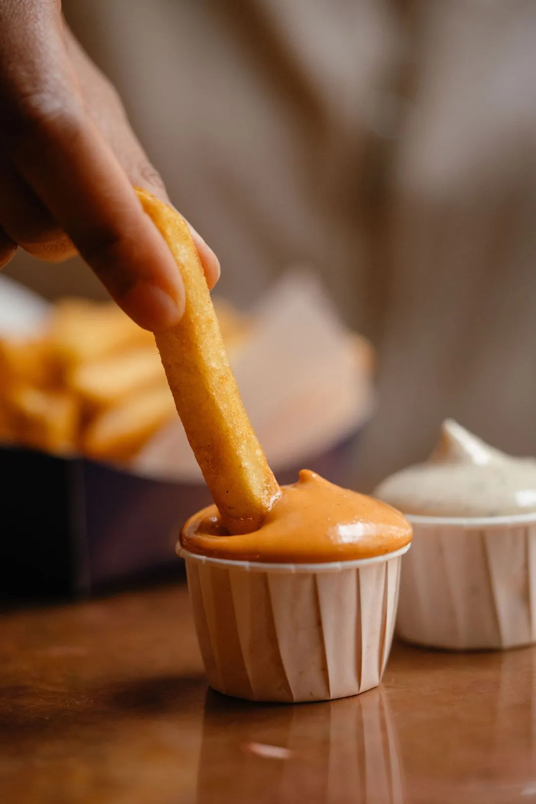 Frites being dipped in sause