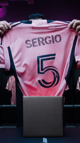 Image of Inter Miami CF player holding up a jersey.