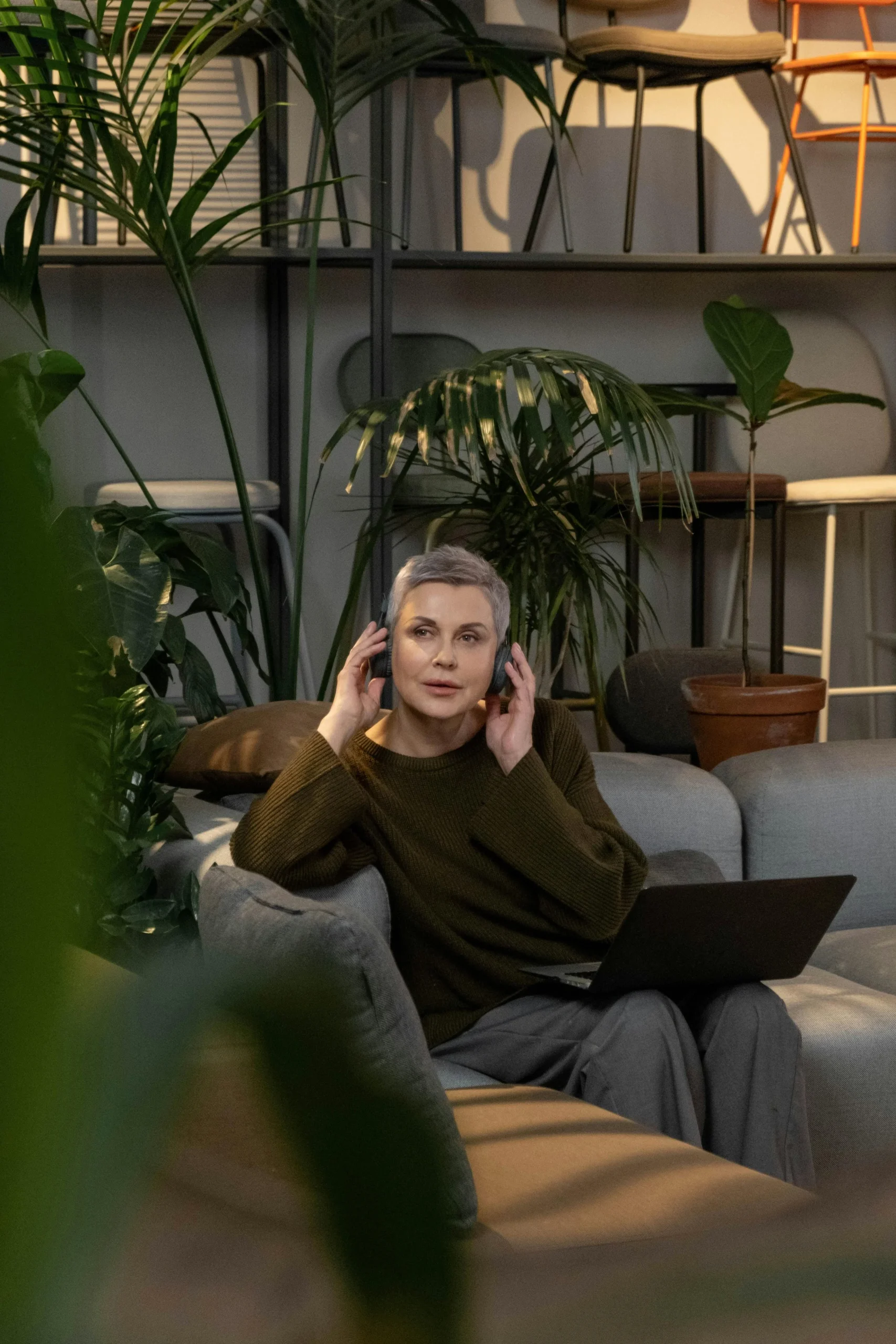 Woman checking Audicin app; HRV 77 ms, listening time 2h10m, nighttime RHR 42 bpm — stress & recovery tracking