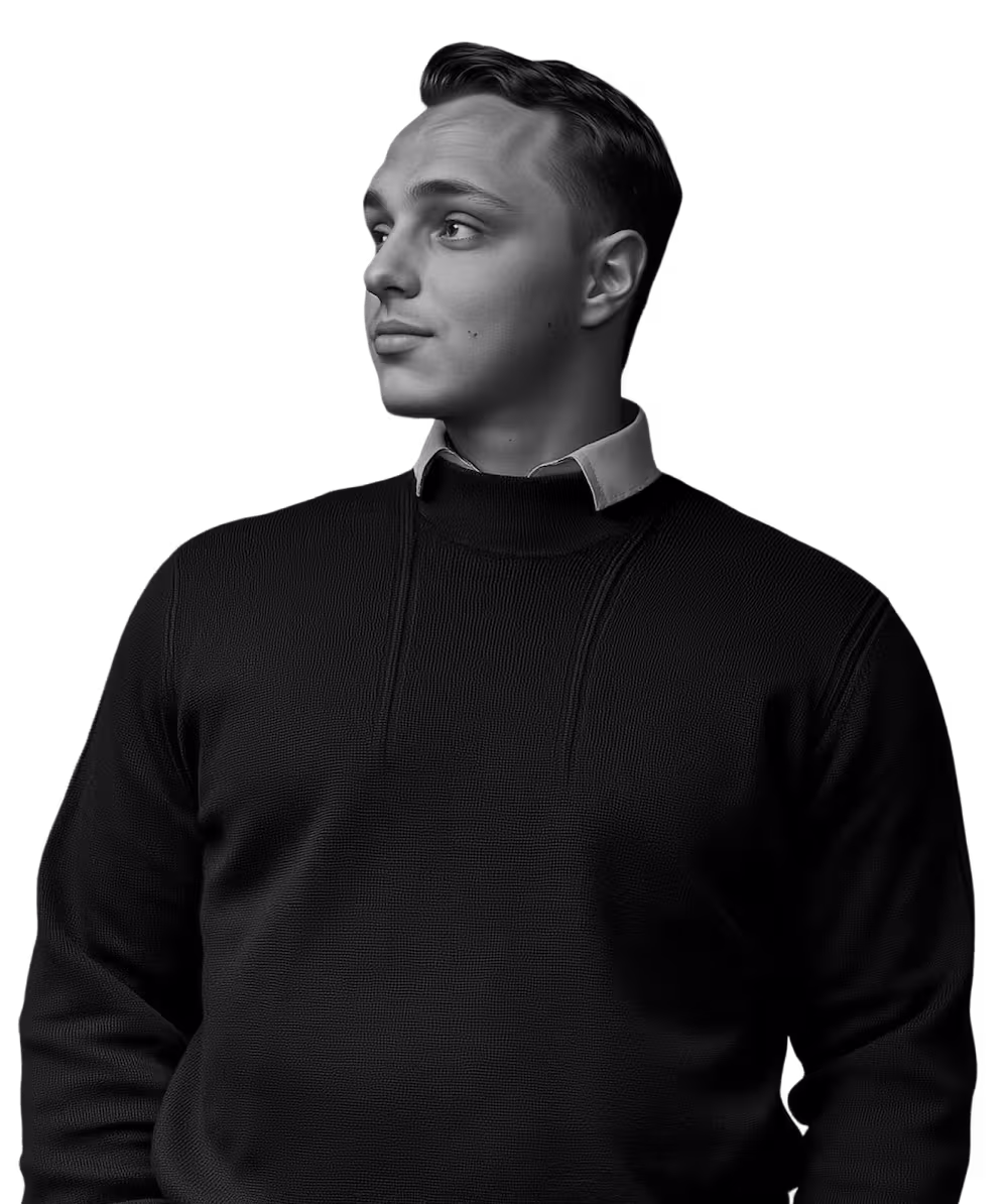 A man wearing a black sweater and a white collar.