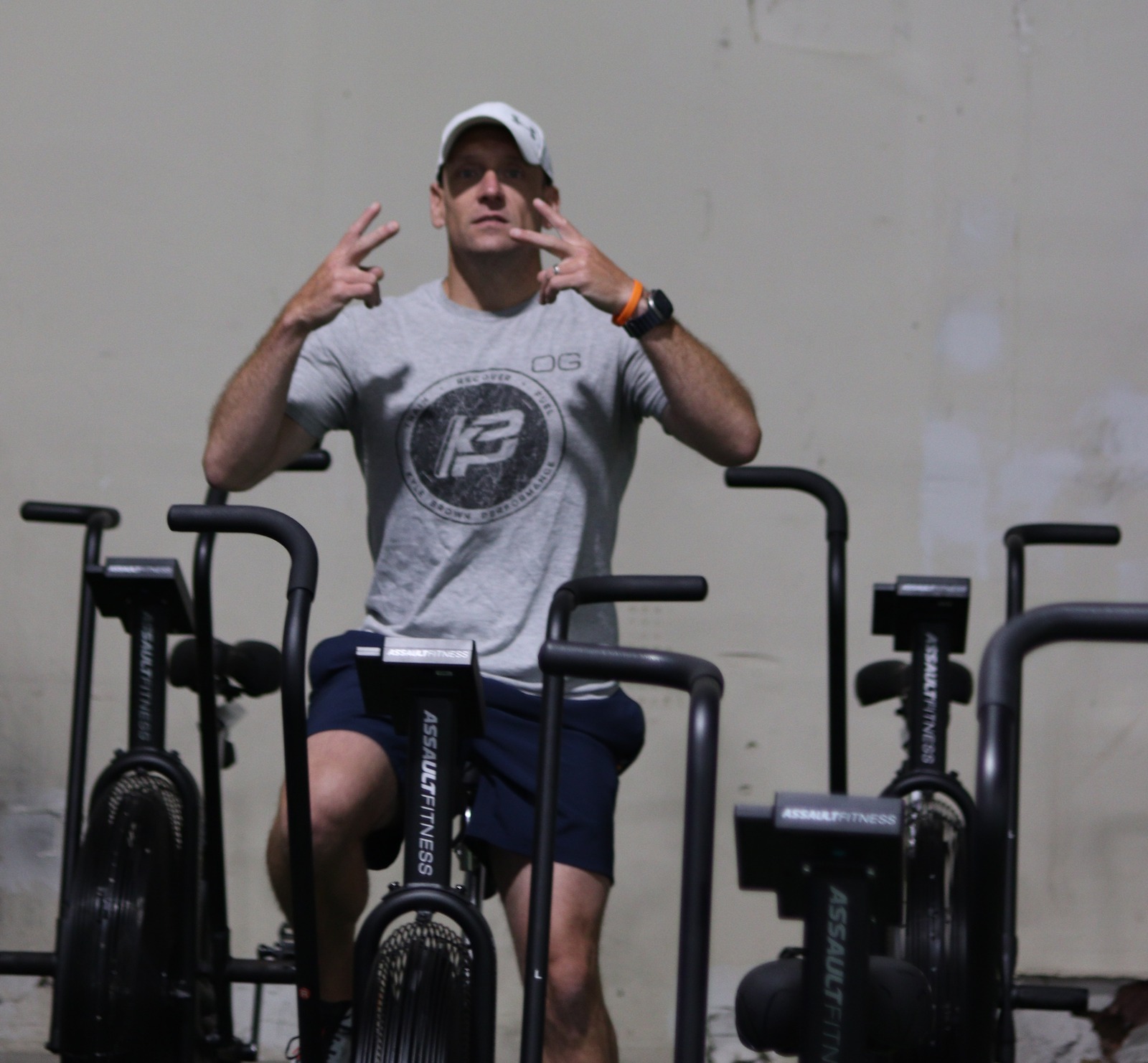 An adult KBP member on an air bike in the new facility.