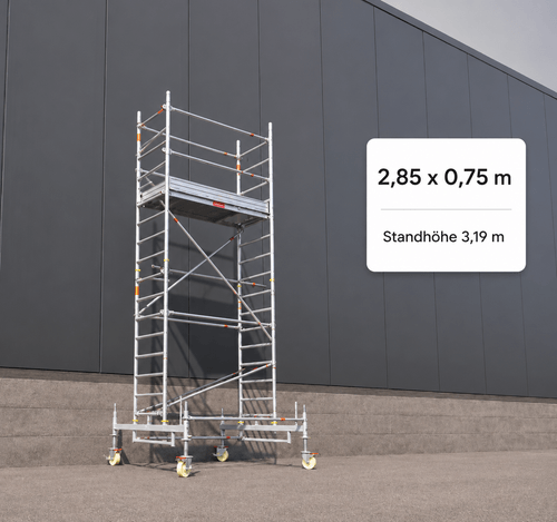 Mobile metal scaffold with wheels standing on concrete floor against dark paneled wall.